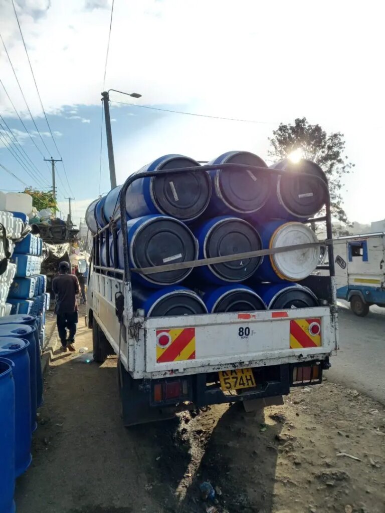 Truck loaded with fermentation tanks filled with coffee cherries in Nyeri Kenya