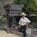Coffee producer Remiery Orlando Carabajal at his farm La Casa in Honduras with processing equipment