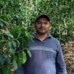 Producer Kelvin Pineda with his coffee cherries in Honduras