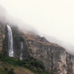 Misty mountains with waterfall view from coffee farm La Papaya in Ecuador