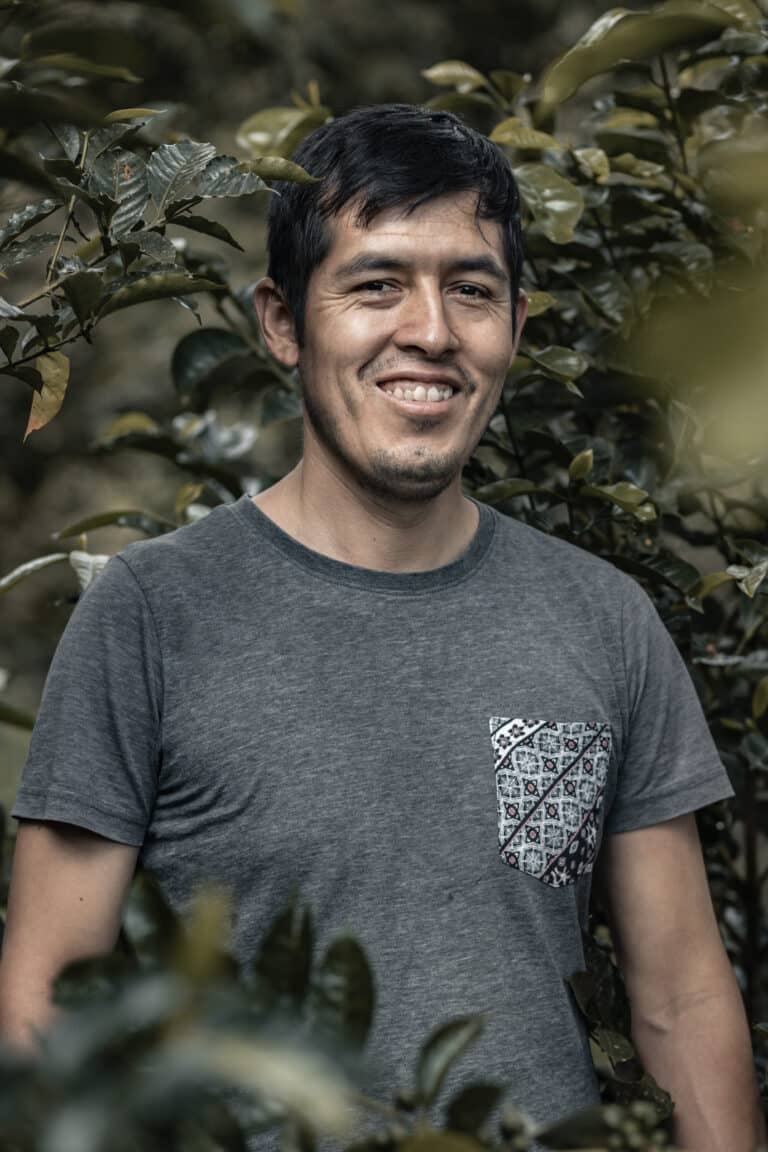Arabica coffee producer Carlos Solorzano standing at his farm Sol Radiante in Peru exported by Three Monkeys Coffee
