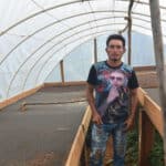 Coffee producer Walter Ramirez at his drying beds under cover for processing at Finca El Pino