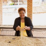 Nova Coffee owner Agnes Mukamushinja holding washed processed green coffee beans in Rwanda